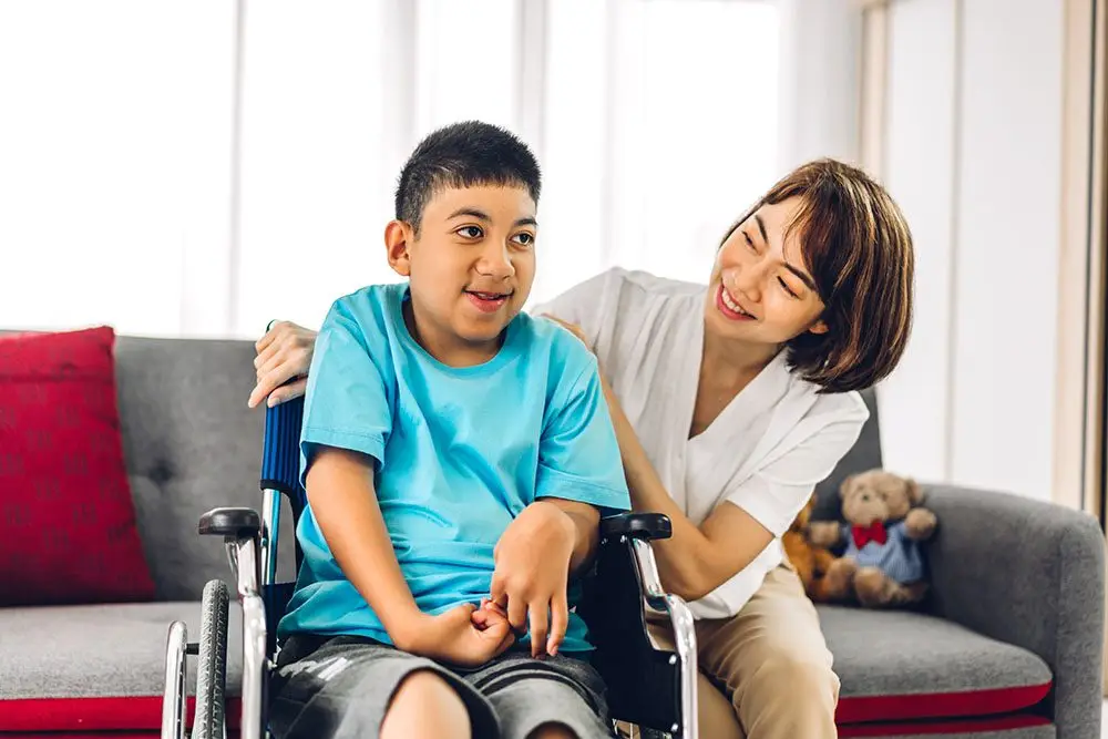 Portrait of happy mother playing and helping her son.