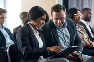 Digital Literacy for Newcomers | Shot of a group of businesspeople using a digital tablets during a conference